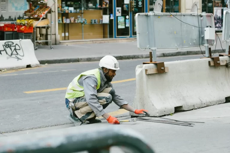 Worker repairing road